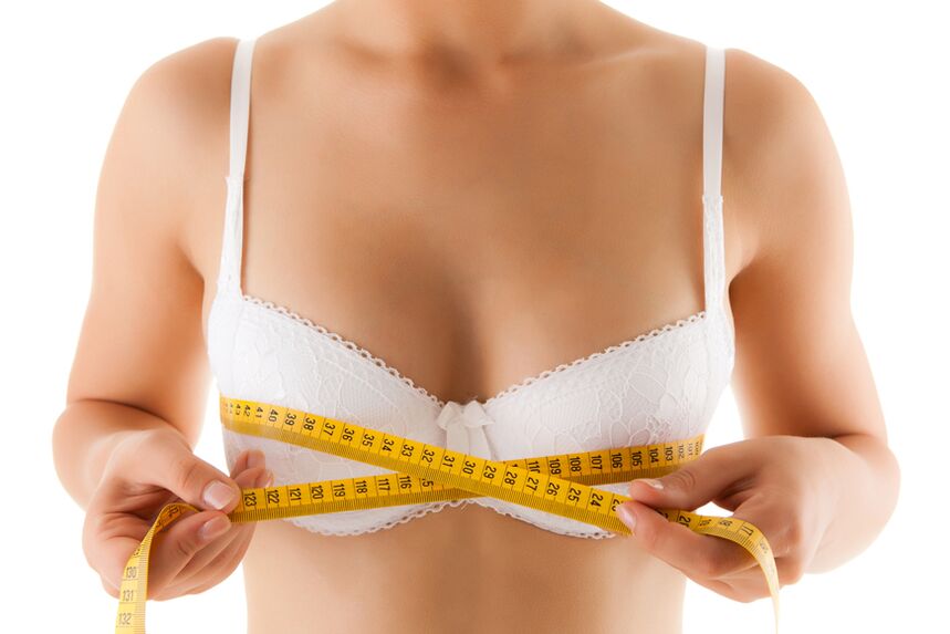 A girl measures her breasts, wanting to increase their size. 
