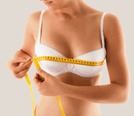 The girl measures the bust with a centimeter